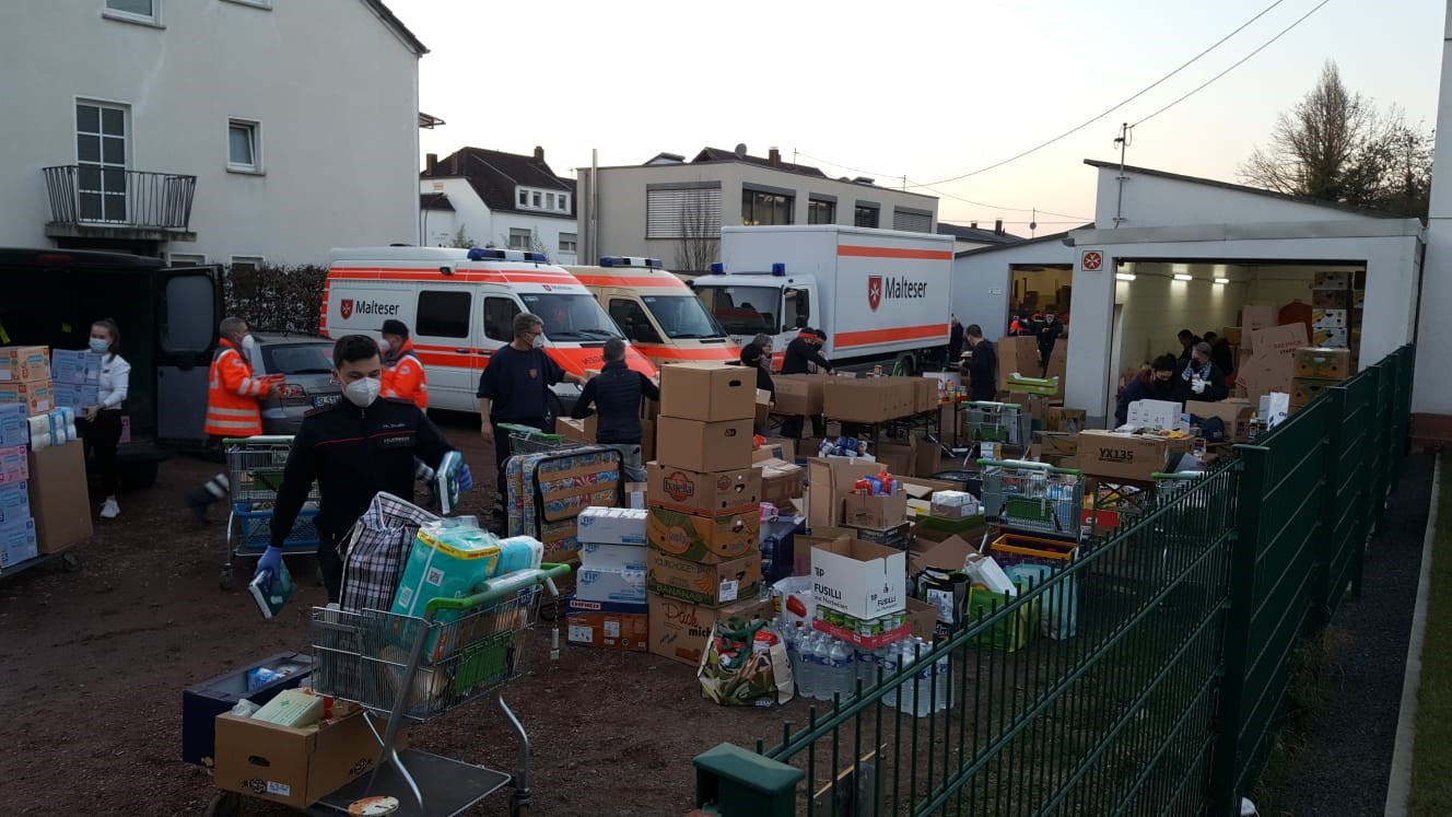 Mehrere Helfer der Malteser Trier vor einer großen LKW-Ladung an Sachspenden für die Ukraine.